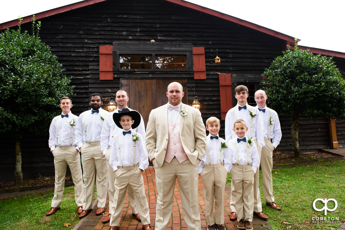 Groom and the groomsmen in front of the barn.