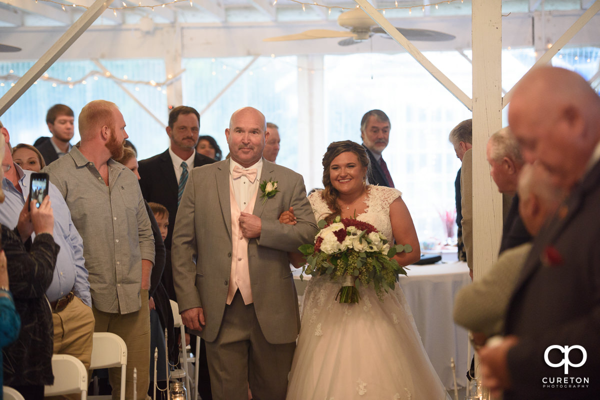 Bride and father walking down the aisle.