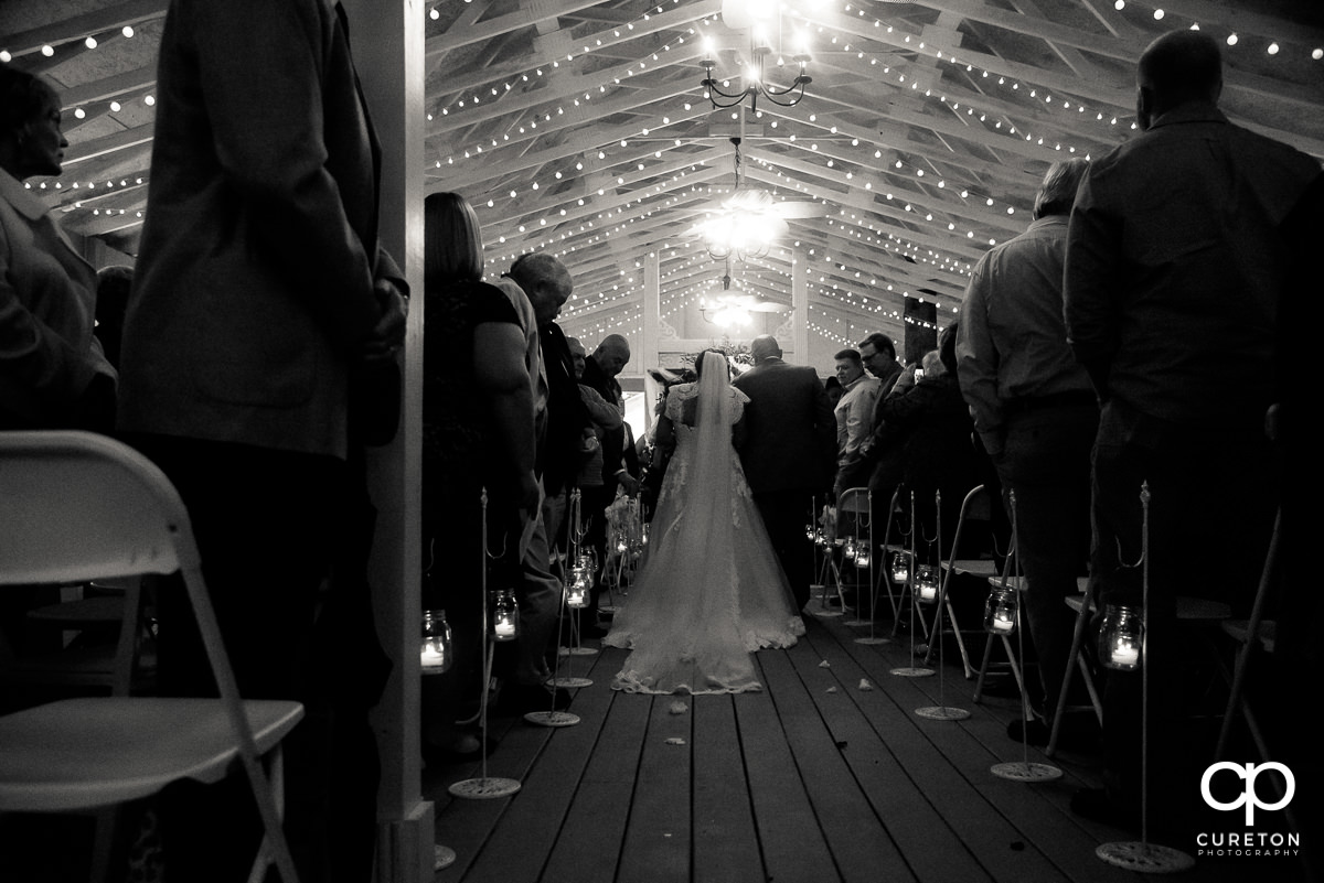 Bride and father walking down the aisle.