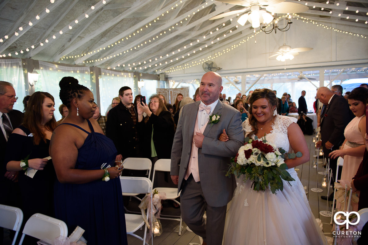 Bride and her dad walking down the aisle.