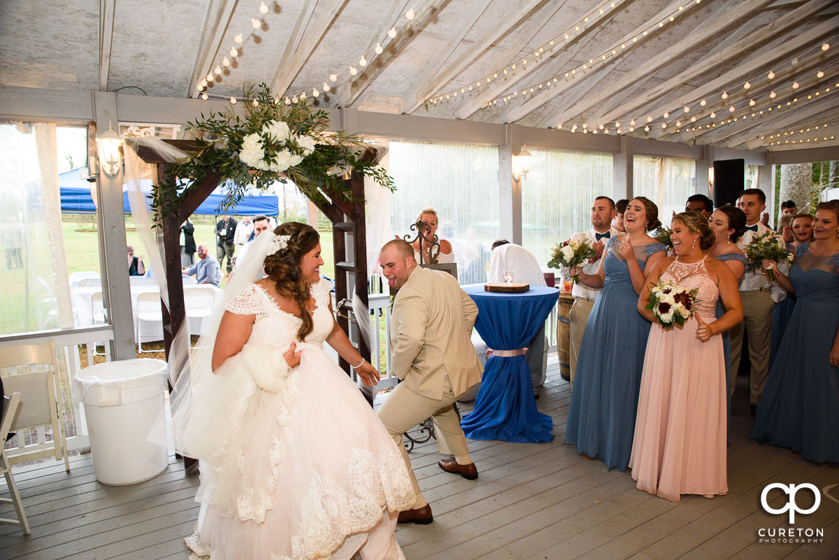 Groom dancing with his bride into the reception.