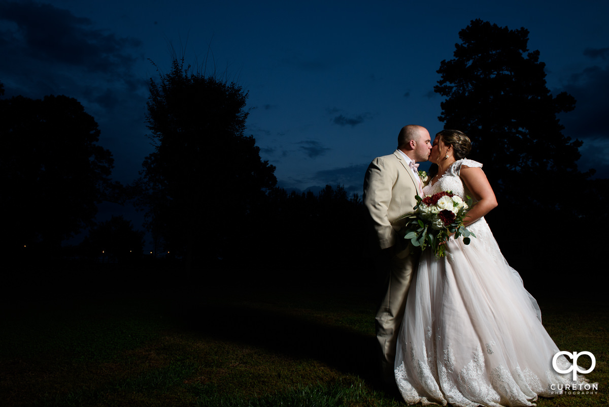 Bride and groom kissing at sunset at The Grove at Pennington.