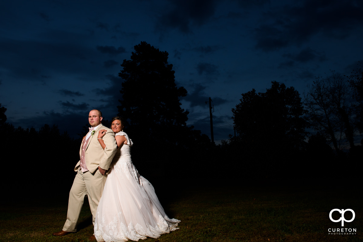 Bride and groom in front of an epic sky at The Grove at Pennington.