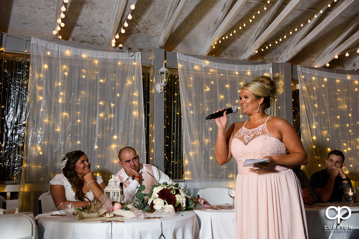 Bride's sister toasts the couple.