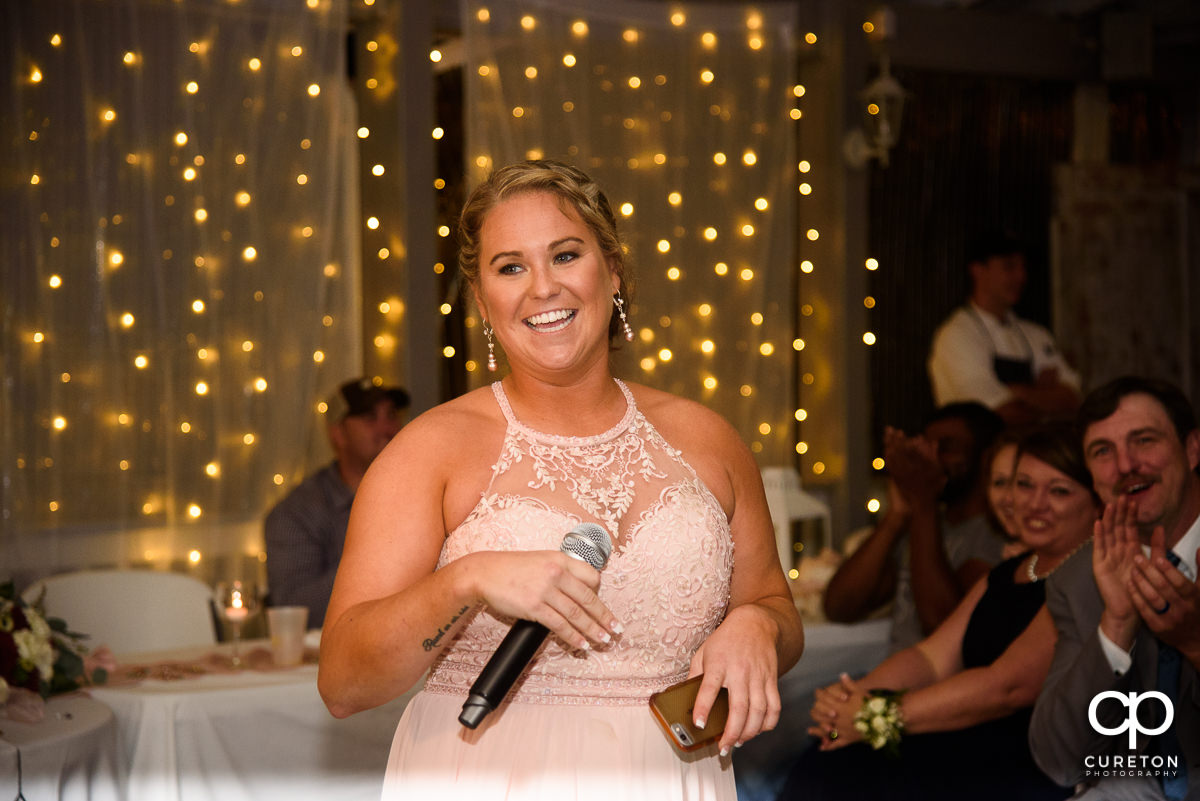 Bride's sister sings them a song.