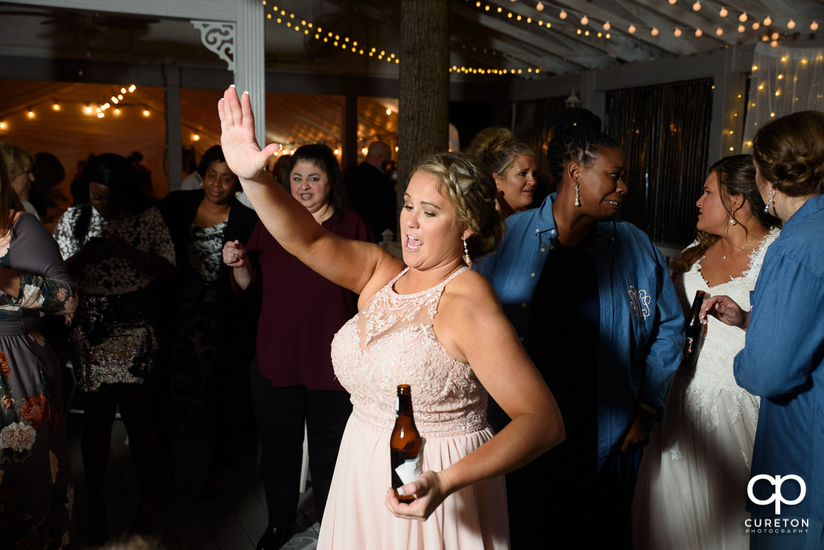 Wedding guests dancing at the reception in the pavilion.