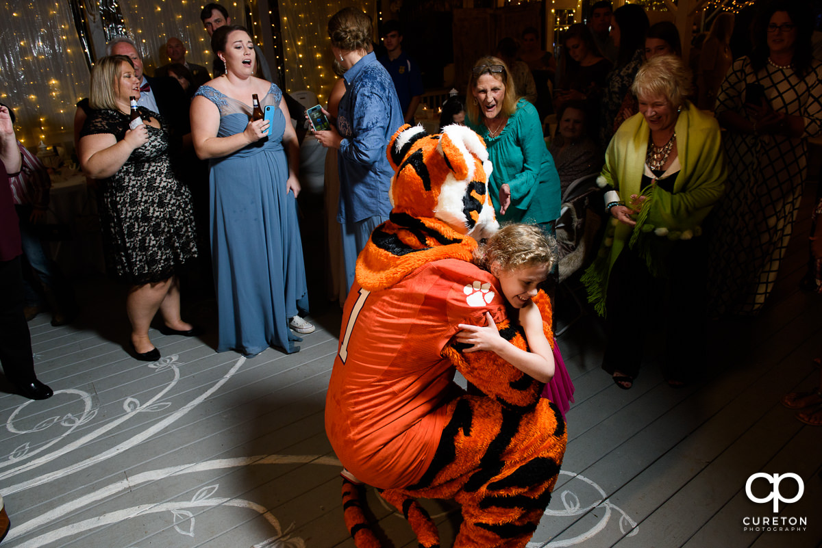 Clemson Tiger hugging a child at the wedding reception at The Grove at Pennington.