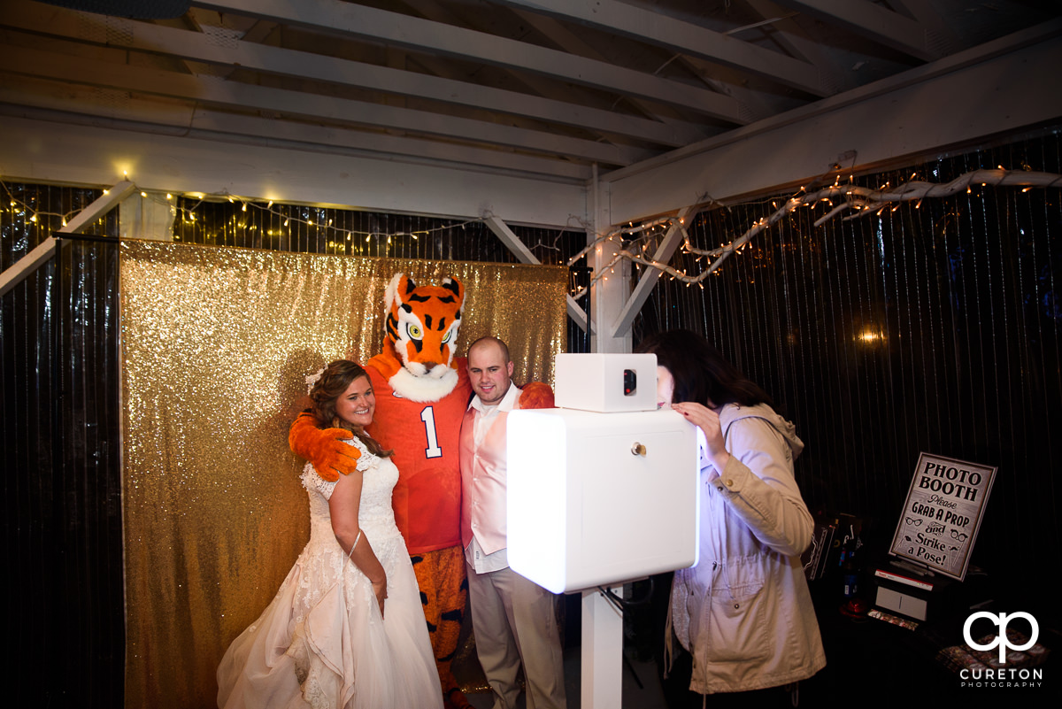 Clemson Tiger with the bride and groom in the Premiere Party Entertainment photo booth.