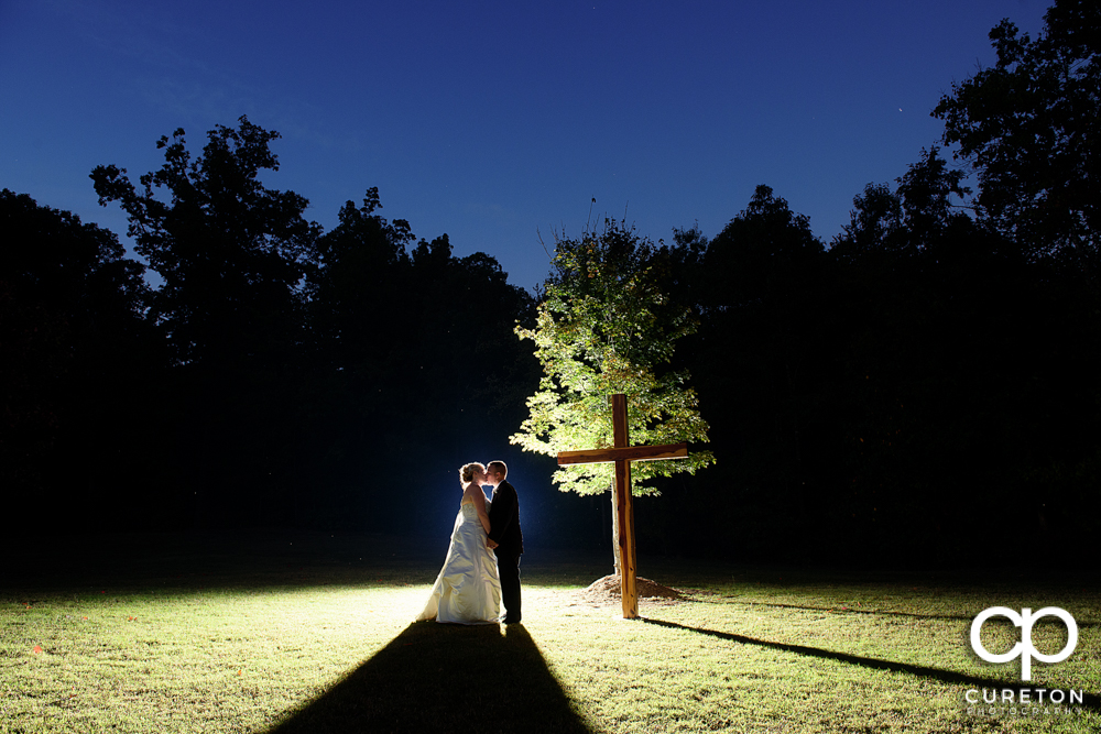 Bride and groom kissing near across at their Hollow at Paris mountain wedding.