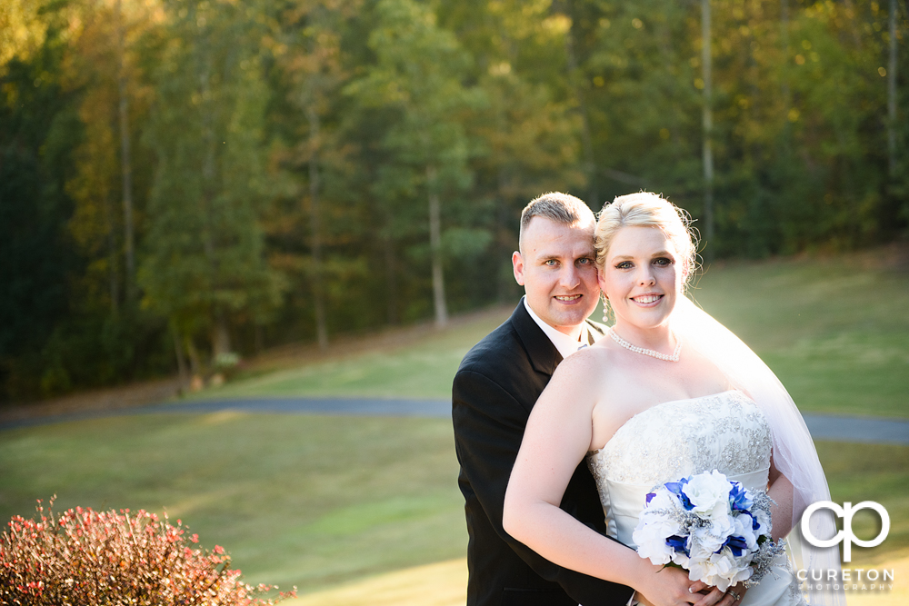 Bride and groom posing outside the hollow at Paris mountain.