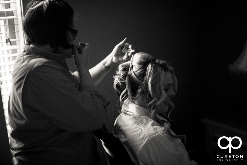 The bride getting her hair done.