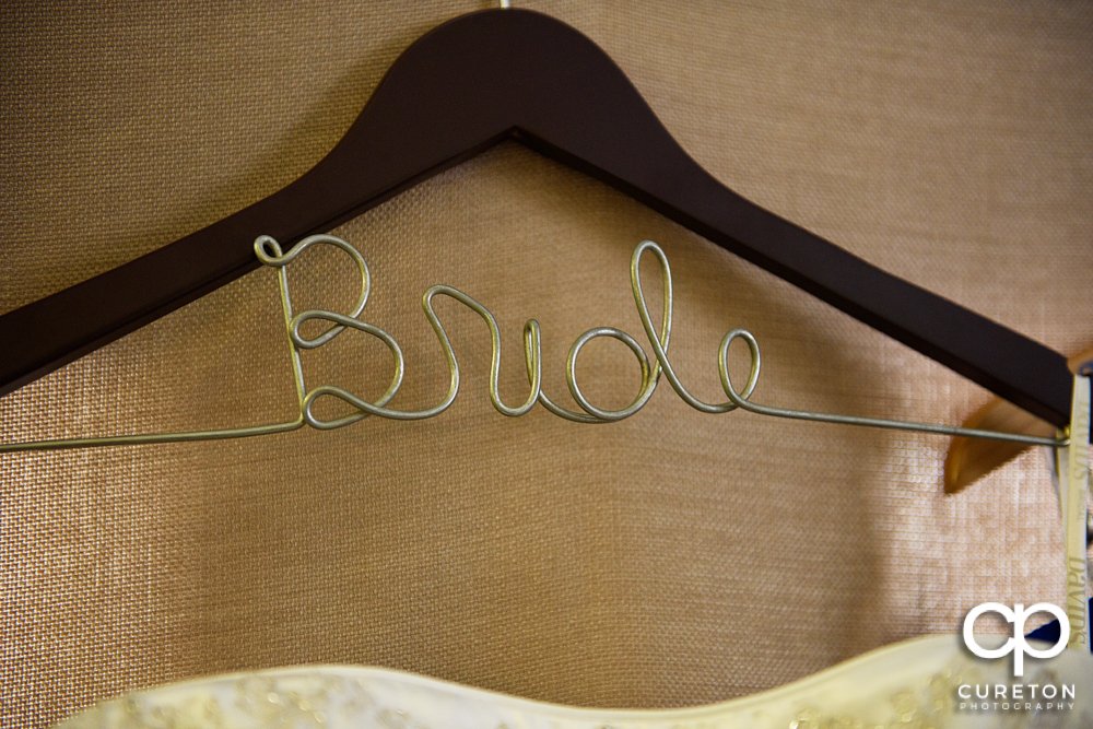 The bride's custom dress hanger.