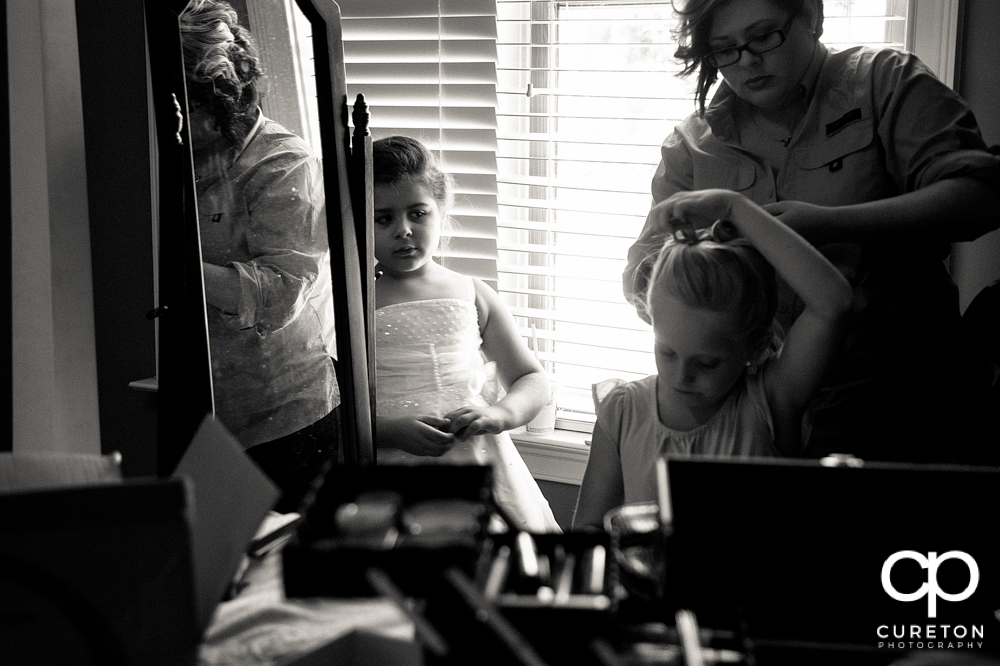 The bride's daughter getting her hair done.