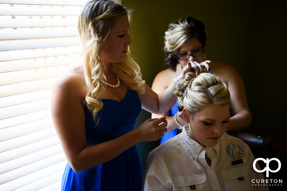 Bride getting her hair and make up done.