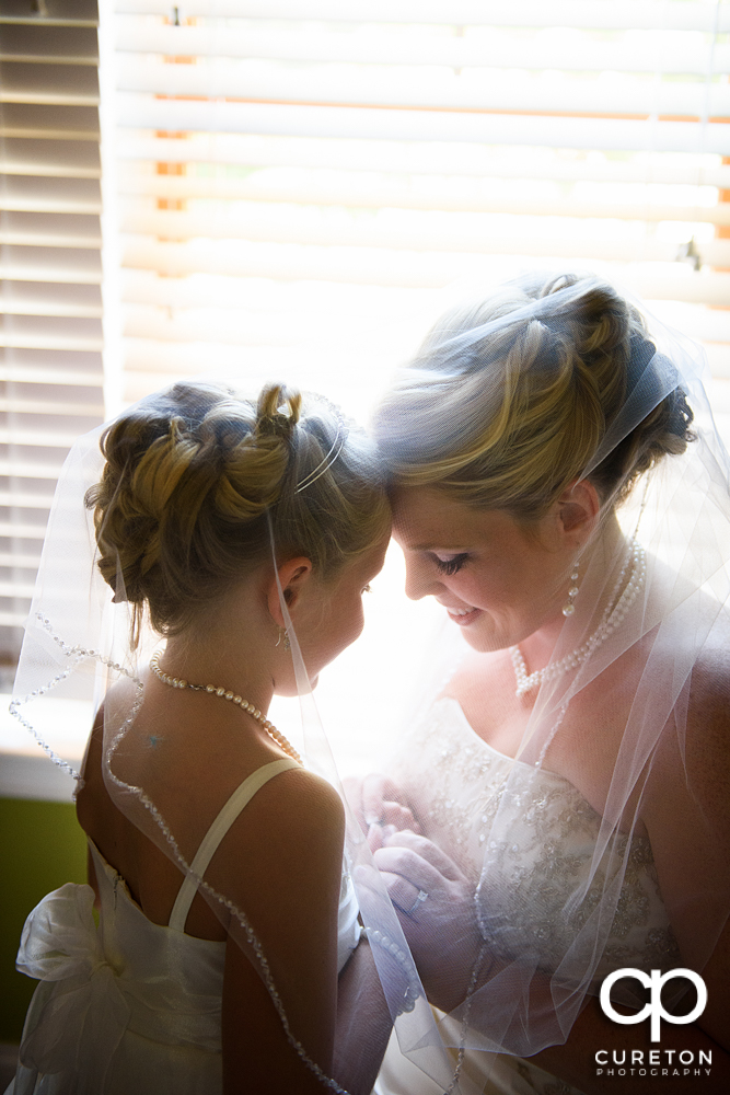 The bride and her daughter sharing a moment before the wedding.
