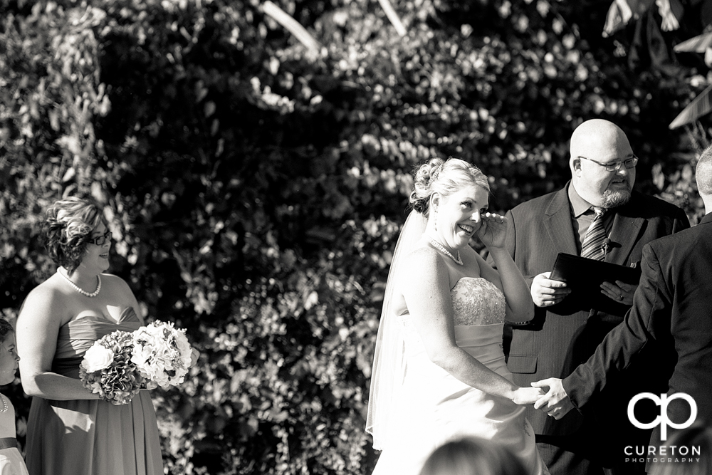 Bride tearing up during the ceremony.