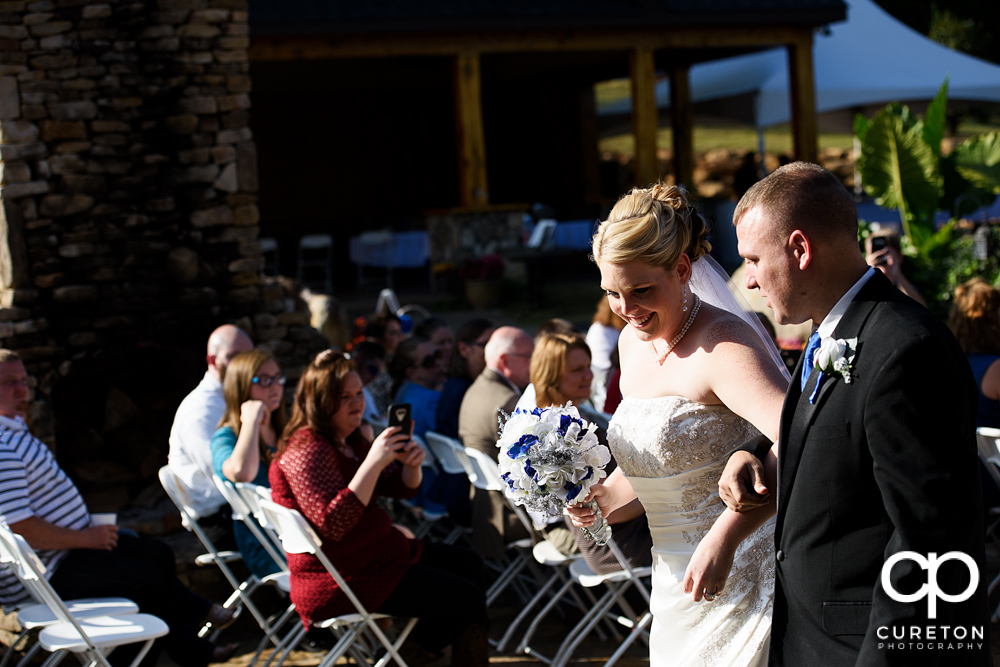 Bride and groom walking back down the aisle.