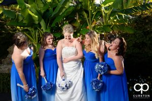 Bride and bridesmaids laughing.