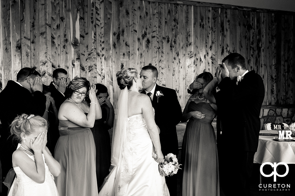 Bride and groom kissing at the reception.