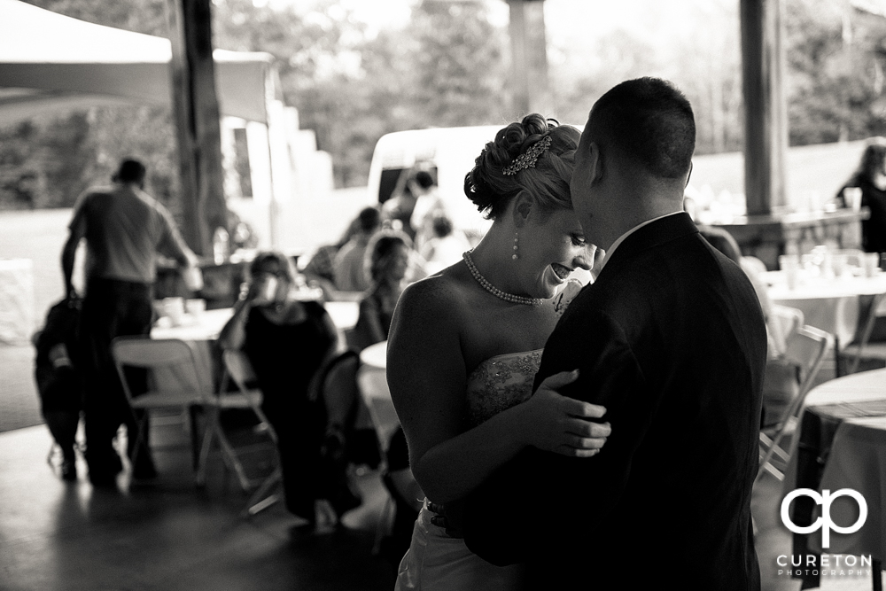 Bride smiling during their first dance.