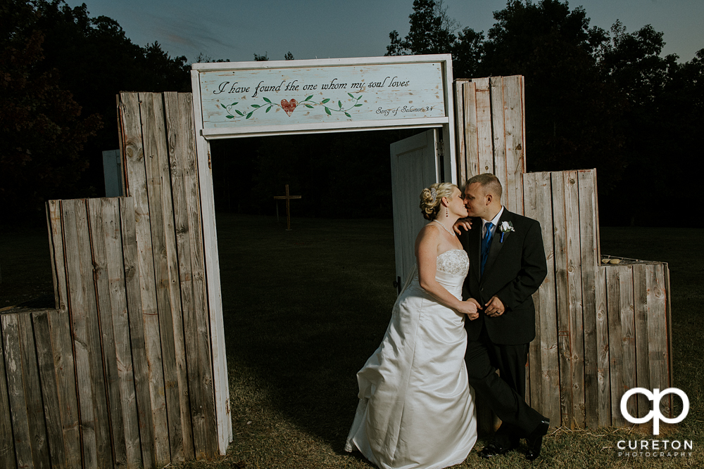 Bride and groom kissing after their wedding at the hollow it Paris mountain.