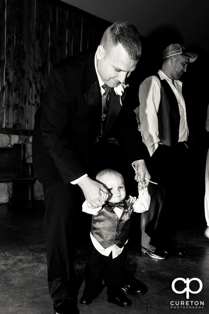 Groom and his son dancing at the wedding.