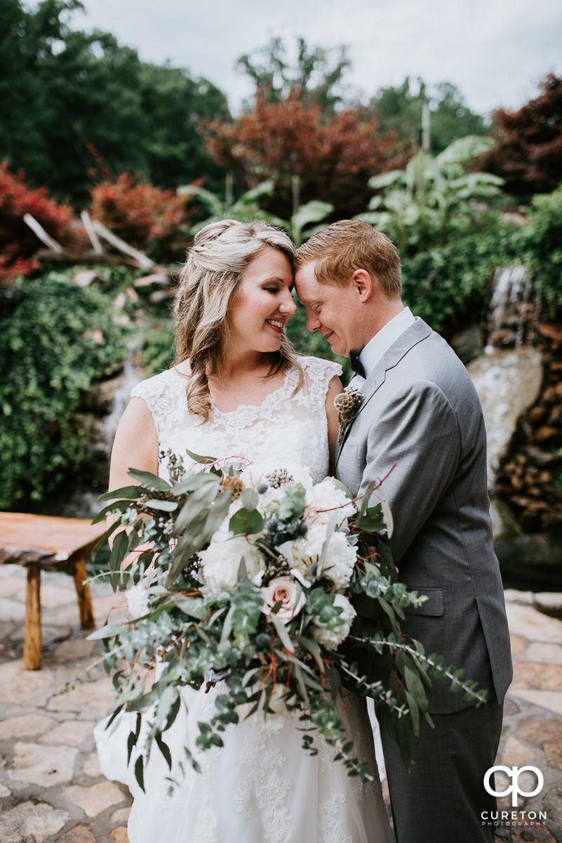 Bride and groom snuggling at their Hollow at Paris Mountain Wedding.