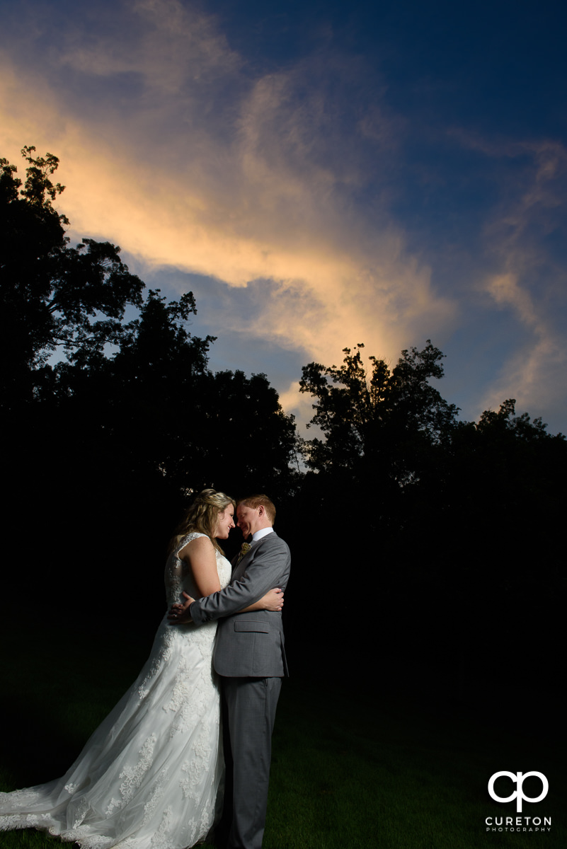 Married couple at The Hollow at Paris Mountain wedding at sunset.