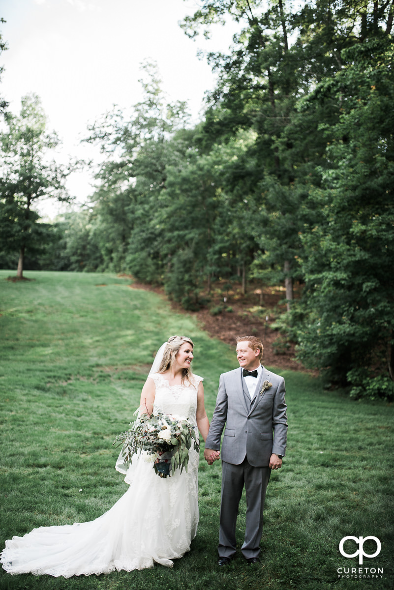 Bride and groom looking at each other after their wedding at The Hollow at Paris Mountain in Greenville,SC.