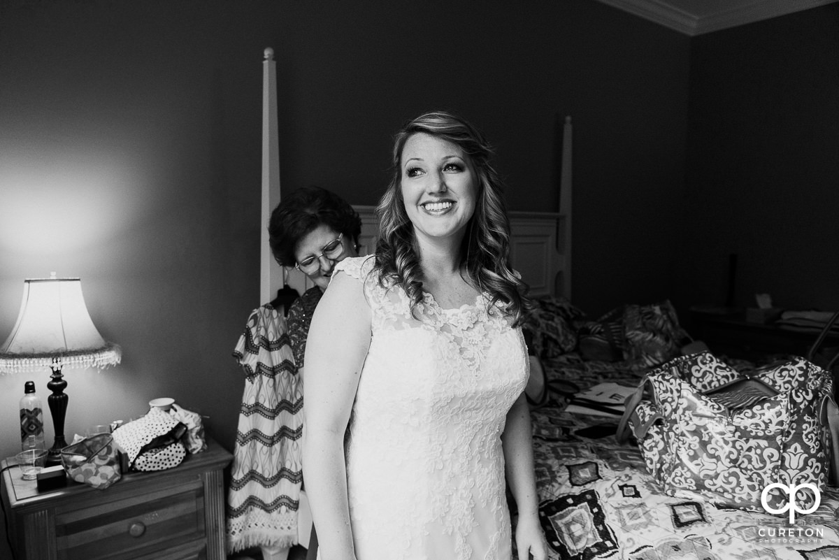 Bride putting on her dress.