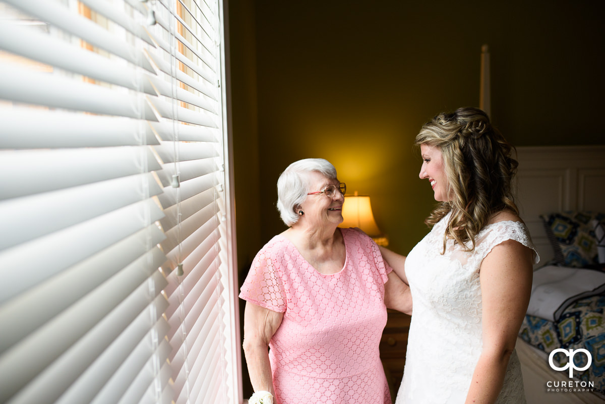 Bride smiling at her grandmother on her wedding day.