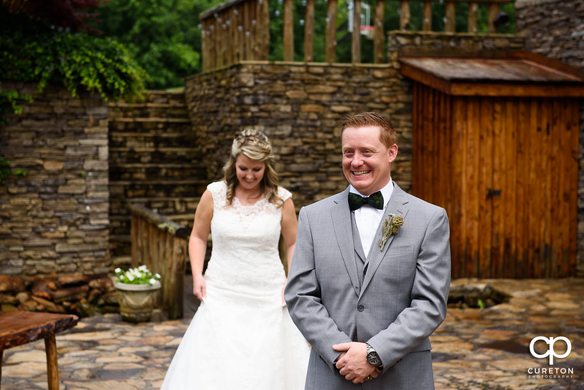 Groom smiling before the first look before the wedding ceremony at The Hollow at Paris Mountain.