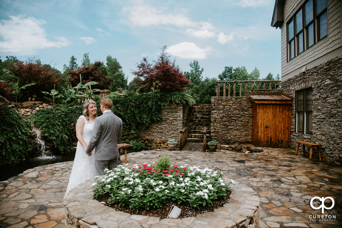 Groom and bride first look at The Hollow at Paris Mountain.