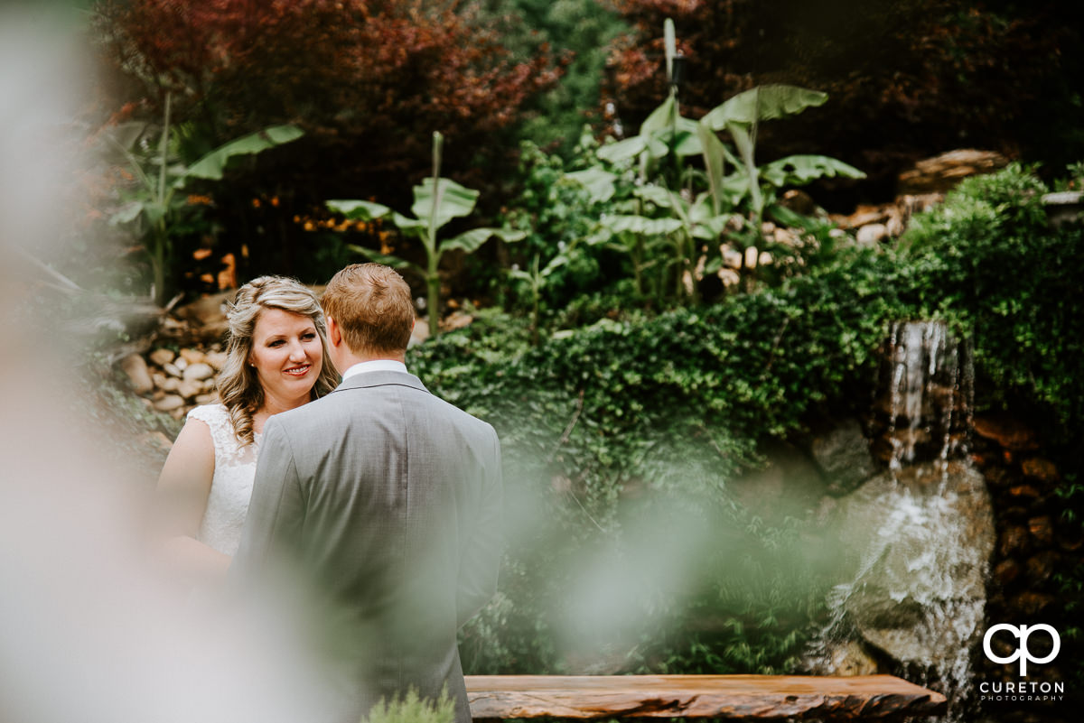 Brode smiling at her groom during their first look.