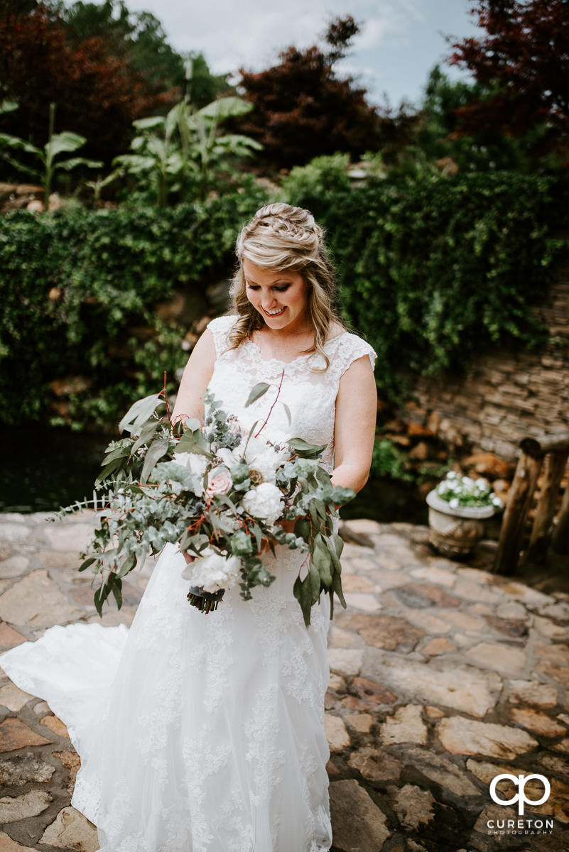 Bride looking at her amazing bouquet.