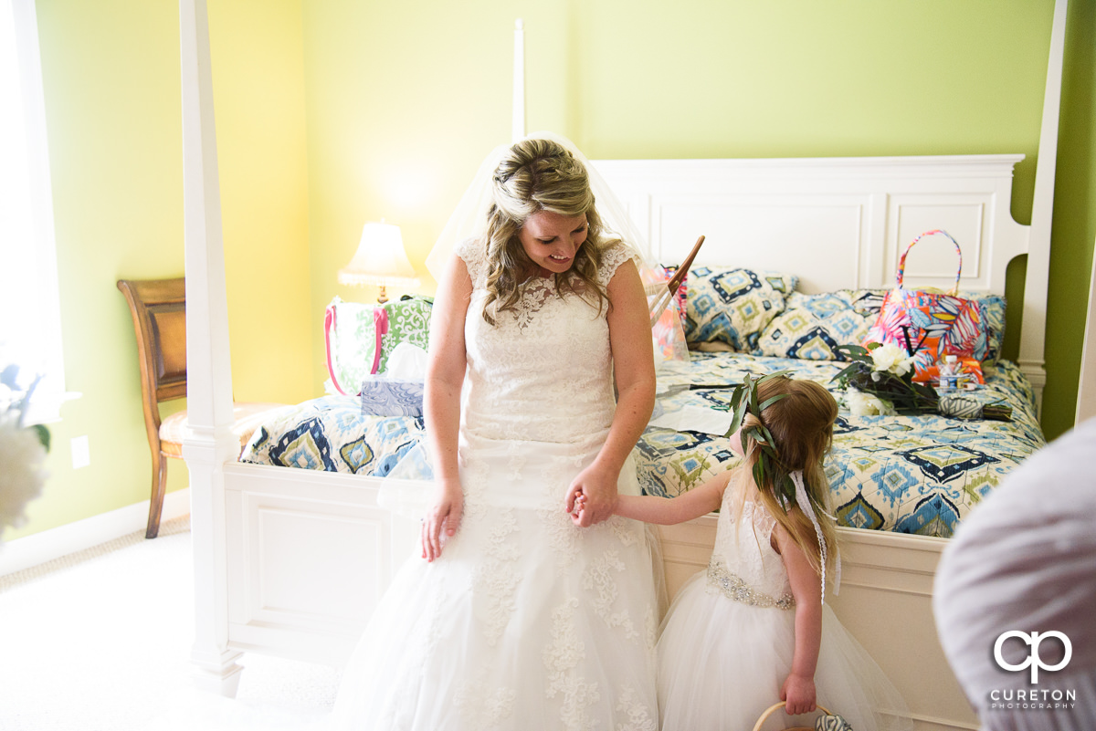 Bride holding the flower girl's hand.