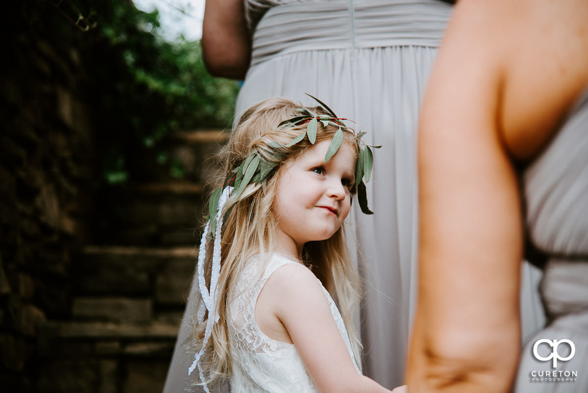 Flower girl looking at the bride.