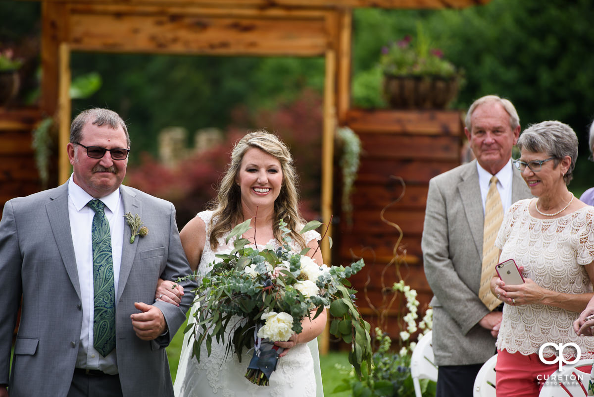 Bride and her father walking down the aisle at The Hollow at Paris Mountain.