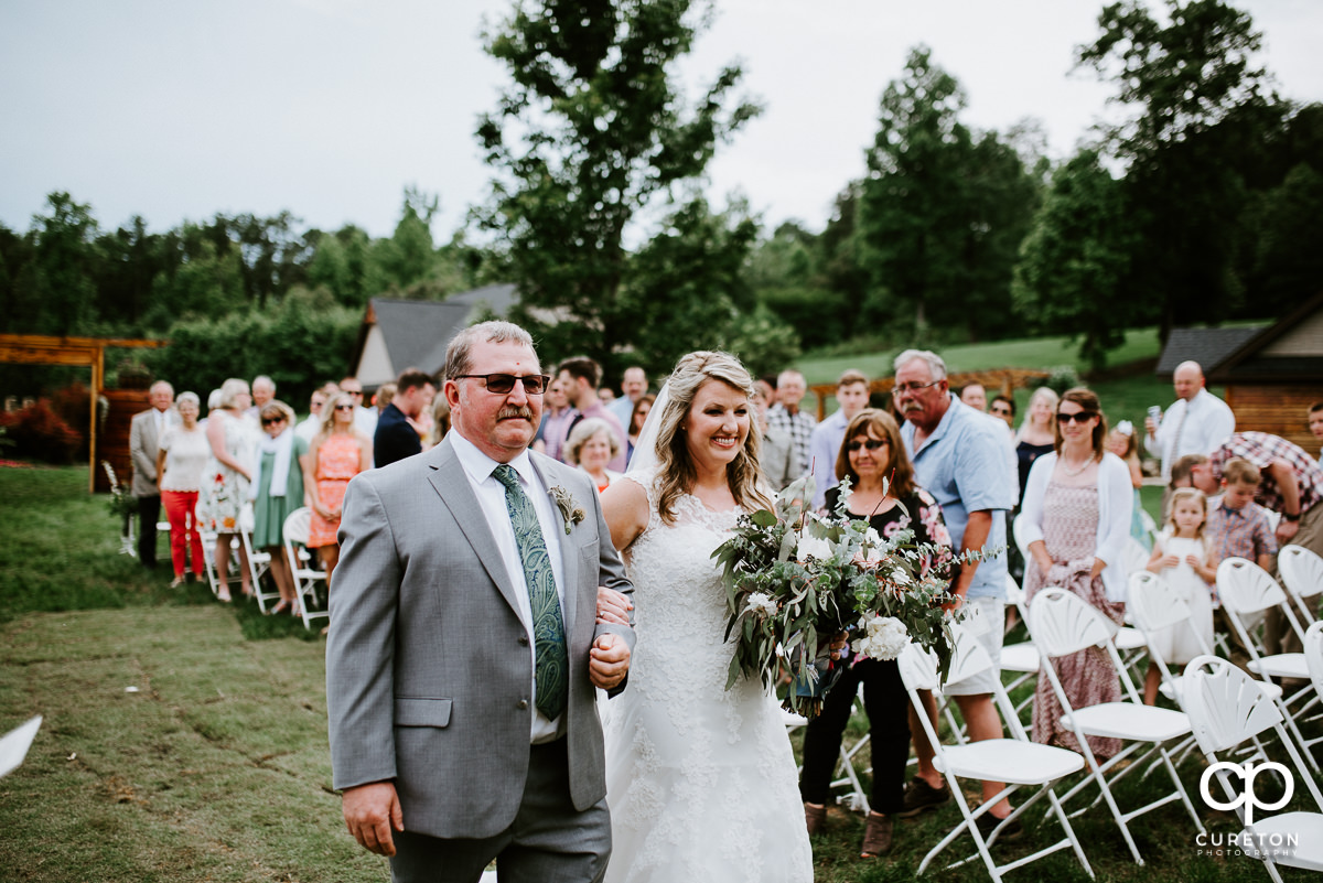 Bride and her father walking down the aisle at her wedding in Greenville,SC.