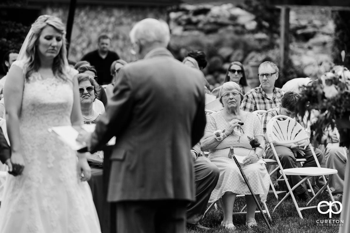 Bride's grandmother watching as she says her vows.