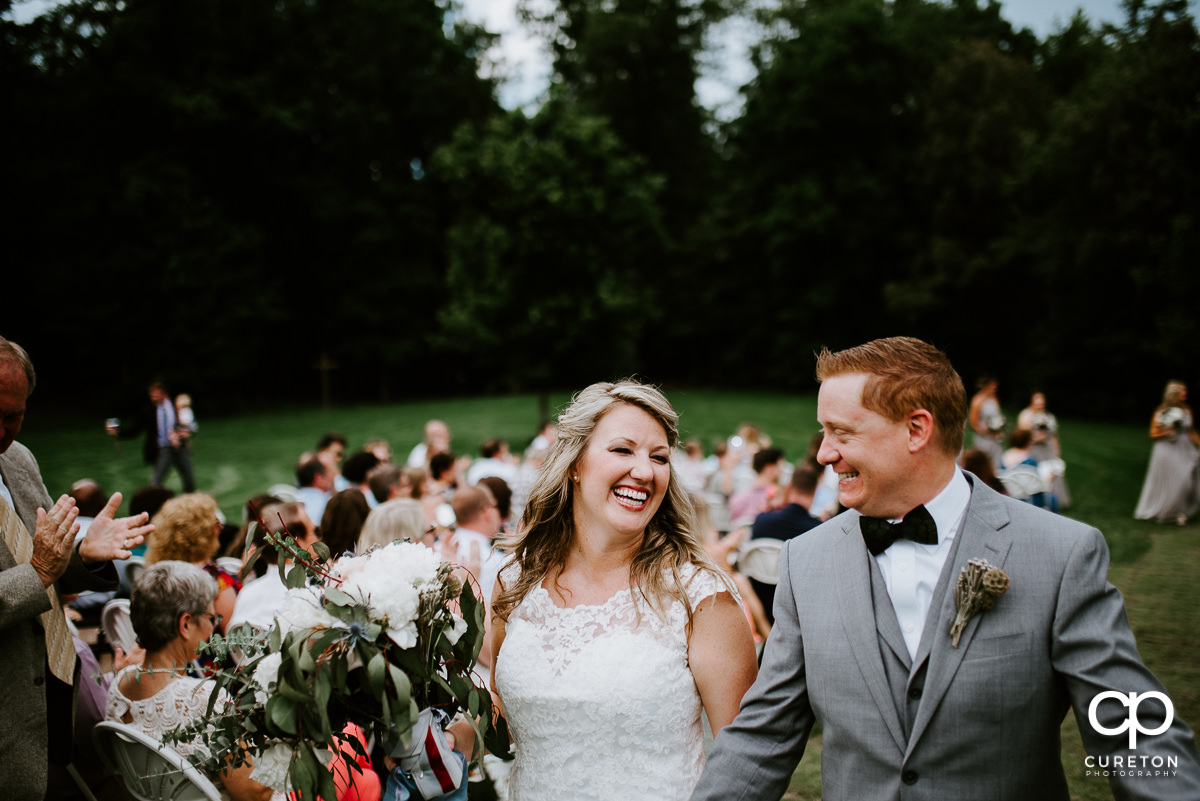 Bride and groom smiling at each other after being pronounced husband and wife.