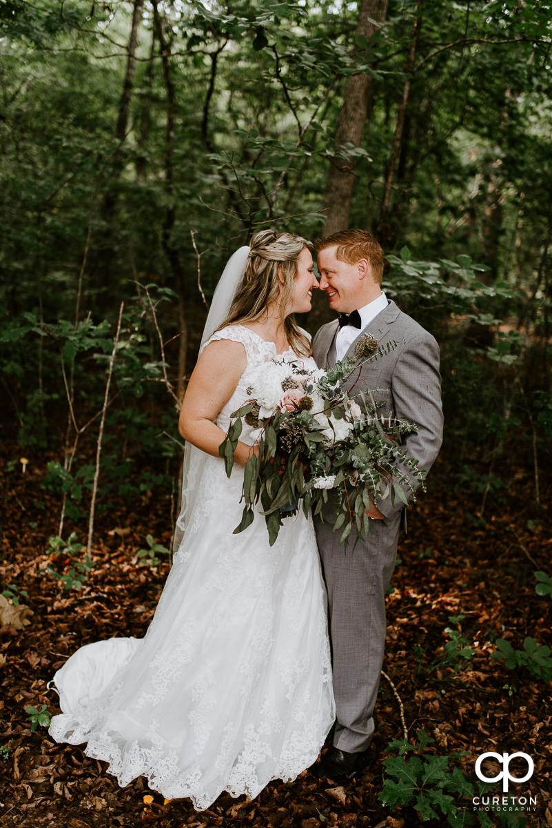 Bride and groom stopping for a moment in the woods after their Hollow at Paris Mountain wedding in Greenville,SC.