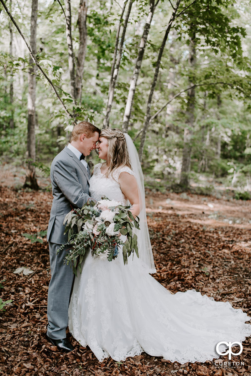 Bride and groom in the forest at their wedding in Greenville,SC.