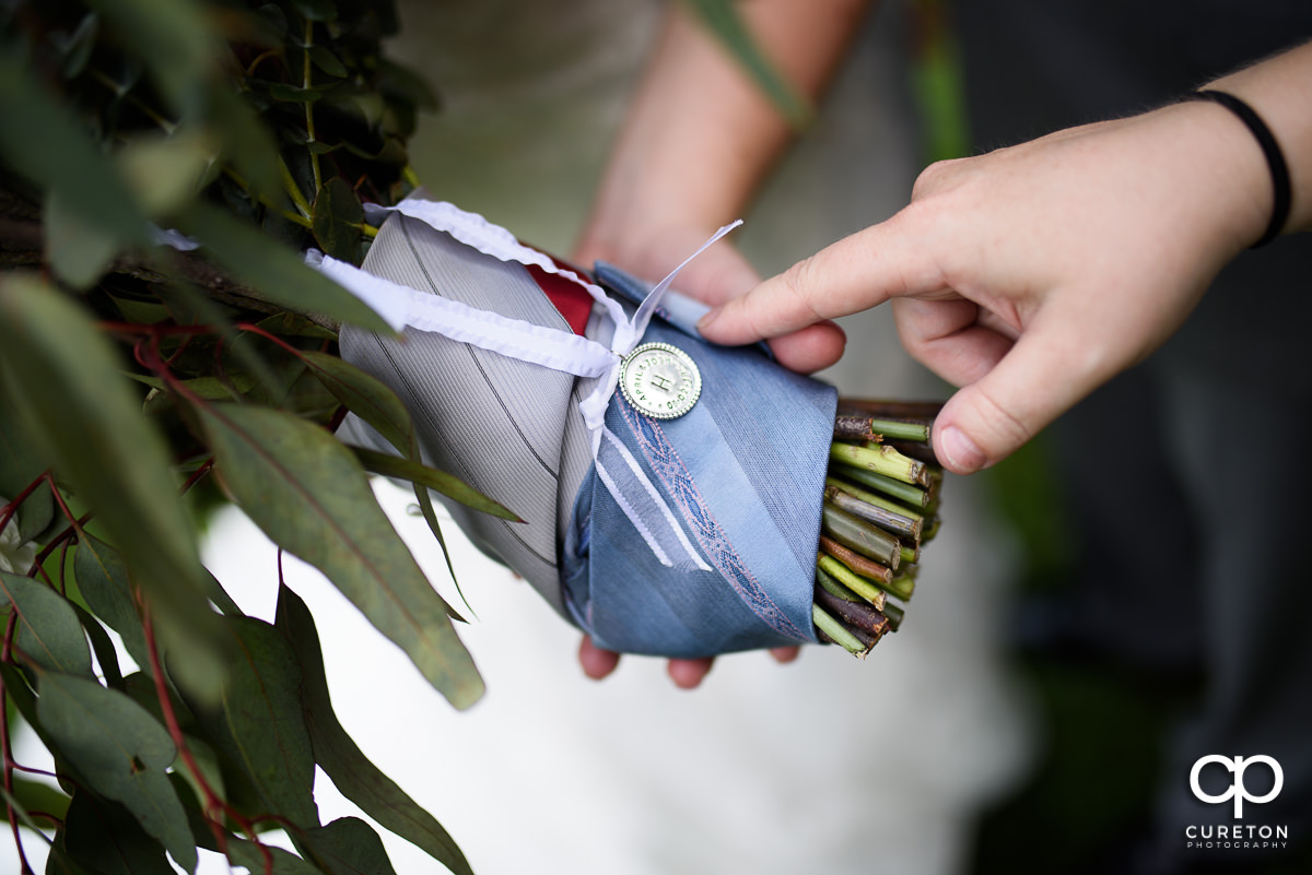 Bride's bouquet held together with her grandfather's ties.