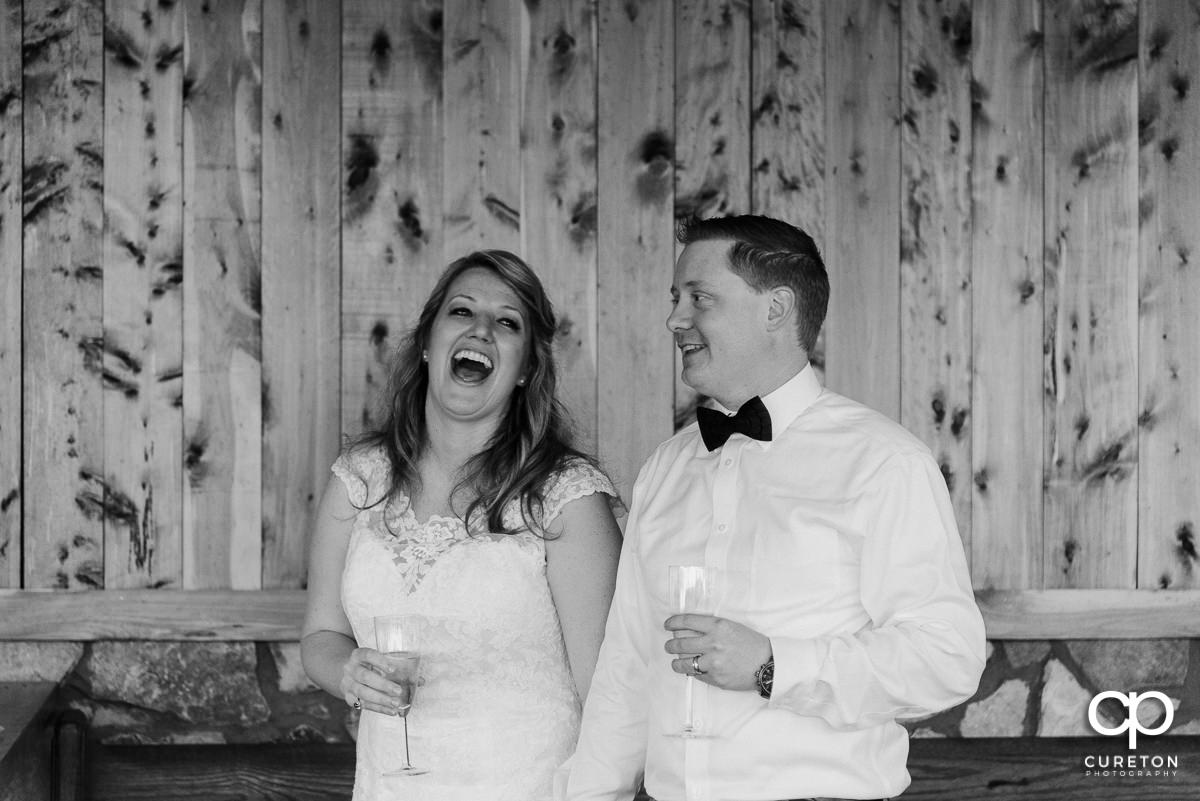 Bride and groom listening to the bridesmaid's speech at the reception.