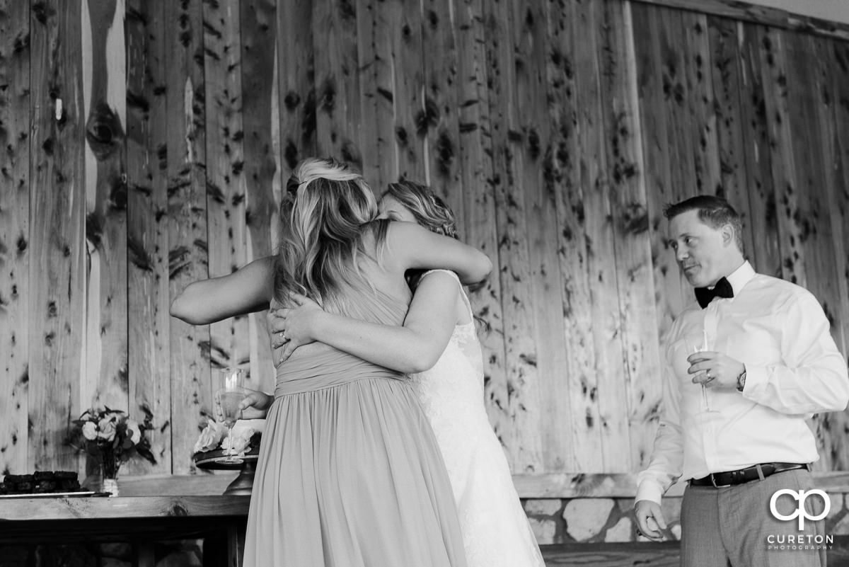 Bride hugging her maid of honor.