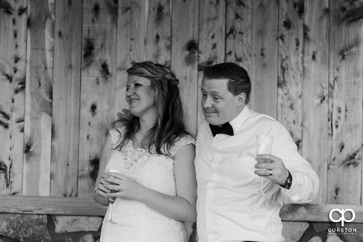 Groom and bride listening to the best man give his speech.