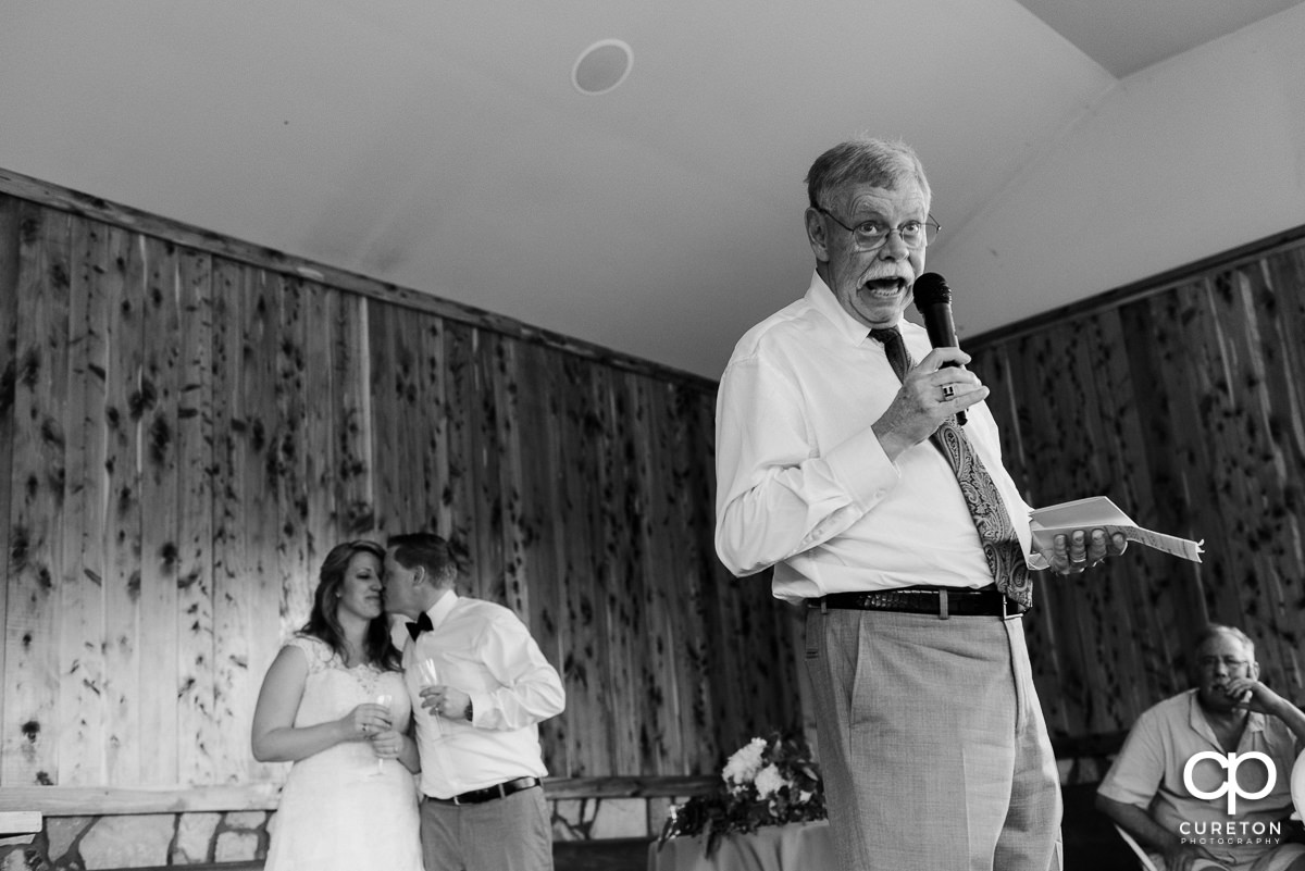 Groom's father giving a speech at his wedding.