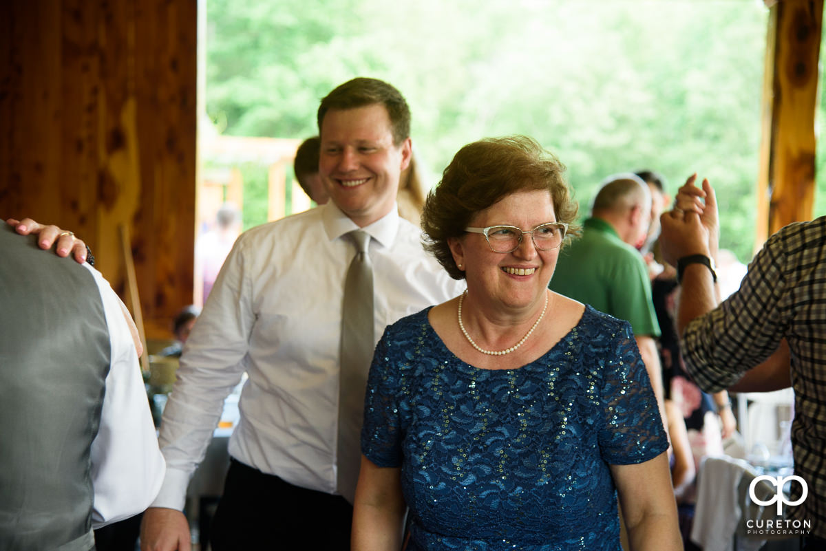 Bride's mom smiling at the wedding reception.