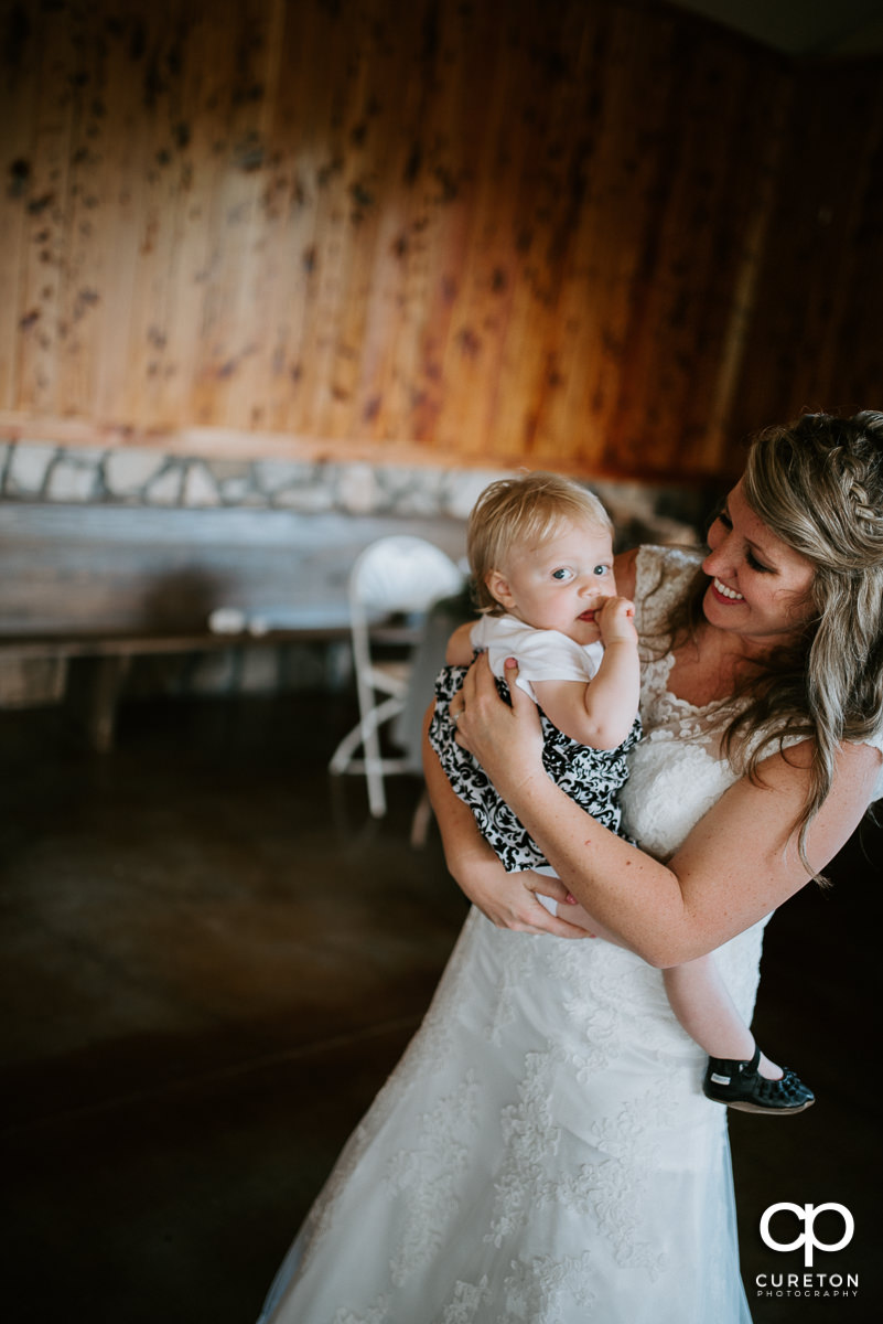Bride dancing with a baby.